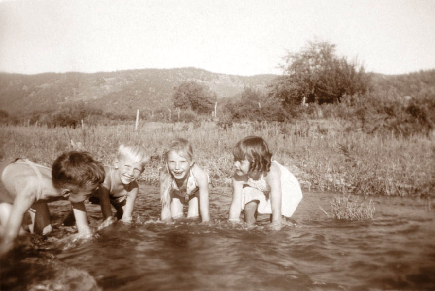 1945-08-25 A.J., Georgia Ruth, and their cousins play in the Ruidoso River on the Harland farm near Biscuit Hill